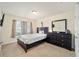 Charming bedroom with a queen bed and dresser at 4585 Sw 112Th Ln, Ocala, FL 34476