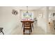 Bright dining area with wood table and four chairs, near kitchen at 4585 Sw 112Th Ln, Ocala, FL 34476