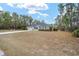 Single-story house with gray siding, blue shutters, and a two-car garage at 4585 Sw 112Th Ln, Ocala, FL 34476