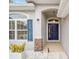 Inviting front entry with navy blue door and stone accents at 4585 Sw 112Th Ln, Ocala, FL 34476