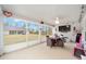 Screened porch features a TV, exercise equipment, and outdoor seating at 4585 Sw 112Th Ln, Ocala, FL 34476