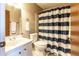 Clean bathroom with a shower/tub combo and striped shower curtain at 512 Bahia Cir # 512B, Ocala, FL 34472