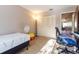 Small bedroom with a twin bed, office chair and view to living room at 512 Bahia Cir # 512B, Ocala, FL 34472