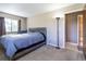Comfortable bedroom with a gray comforter and ensuite bathroom access at 512 Bahia Cir # 512B, Ocala, FL 34472