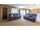 Living room with two reclining sofas and sliding glass doors at 512 Bahia Cir # 512B, Ocala, FL 34472