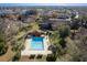Aerial view of community pool, patio furniture, and surrounding buildings at 512 Bahia Cir # 512B, Ocala, FL 34472
