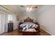 Bright bedroom featuring a wooden bed and access to outdoor space at 5498 Sw 80Th Pl, Ocala, FL 34476