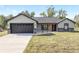 Modern one-story home with gray siding and a dark gray roof at 61 Water Track Loop, Ocala, FL 34472