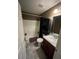 Bathroom with tub shower and dark vanity at 6701 Se 122Nd Ln, Belleview, FL 34420
