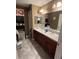 Double vanity bathroom with dark cabinets at 6701 Se 122Nd Ln, Belleview, FL 34420