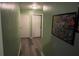 Clean hallway with light walls and wood floors at 6701 Se 122Nd Ln, Belleview, FL 34420