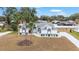 Aerial view of a single-story home with a well-manicured lawn and a long driveway at 7528 Sw 102Nd Loop, Ocala, FL 34476