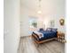 Cozy bedroom with vaulted ceiling, hardwood floors, natural light, and calming color palette at 7528 Sw 102Nd Loop, Ocala, FL 34476