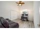 Bright bedroom featuring wood-look flooring, a ceiling fan, and a functional work space by the window at 7528 Sw 102Nd Loop, Ocala, FL 34476