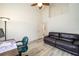 View of the bedroom showing wood-look floors, a ceiling fan, and neutral walls that create a relaxing atmosphere at 7528 Sw 102Nd Loop, Ocala, FL 34476