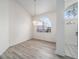 Bright dining area with laminate flooring, arched windows, and a decorative light fixture at 7528 Sw 102Nd Loop, Ocala, FL 34476
