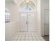 Bright foyer showcases double entry doors and elegant grid tile flooring at 7528 Sw 102Nd Loop, Ocala, FL 34476