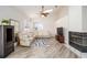 Living room featuring laminate floors, a modern leather sectional, and a corner fireplace at 7528 Sw 102Nd Loop, Ocala, FL 34476