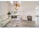 Bright living room with vaulted ceilings, laminate flooring, and sliding glass doors to outdoor space at 7528 Sw 102Nd Loop, Ocala, FL 34476