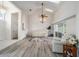 Bright living area with laminate flooring, vaulted ceilings, skylights, and access to other rooms at 7528 Sw 102Nd Loop, Ocala, FL 34476