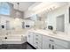 Elegant main bathroom features a jetted tub, a chandelier, and and sinks at 7528 Sw 102Nd Loop, Ocala, FL 34476