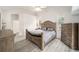 Comfortable main bedroom features an ensuite bathroom, large windows, and modern, wood-look flooring at 7528 Sw 102Nd Loop, Ocala, FL 34476