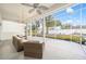 Inviting screened-in patio featuring plush wicker furniture and views of the serene backyard oasis at 7528 Sw 102Nd Loop, Ocala, FL 34476