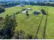 Aerial view of a large equestrian property with multiple paddocks and a home at 7675 W Highway 326, Ocala, FL 34482