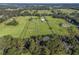 Wide aerial view of the property and surrounding equestrian community at 7675 W Highway 326, Ocala, FL 34482