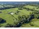 Aerial view showing a large equestrian property with paddocks and a house at 7675 W Highway 326, Ocala, FL 34482