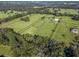 Aerial view showcasing expansive property with equestrian facilities at 7675 W Highway 326, Ocala, FL 34482