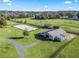 Aerial view of equestrian property with barn, arena, and paddocks at 7675 W Highway 326, Ocala, FL 34482