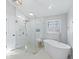 Bathroom with walk-in shower, soaking tub, and window at 7675 W Highway 326, Ocala, FL 34482