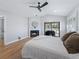 Main bedroom with fireplace, hardwood floors, and patio access at 7675 W Highway 326, Ocala, FL 34482