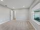Simple bedroom with carpet flooring and a large window at 7675 W Highway 326, Ocala, FL 34482
