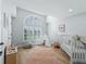 Bright bedroom with large window, hardwood floors, and playful decor at 7675 W Highway 326, Ocala, FL 34482