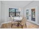 Charming breakfast nook with white table and chairs, overlooking the pool area at 7675 W Highway 326, Ocala, FL 34482