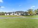 White brick home with palm tree and circular driveway at 7675 W Highway 326, Ocala, FL 34482