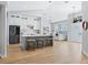 Open concept kitchen with island, stainless steel appliances, and light hardwood floors at 7675 W Highway 326, Ocala, FL 34482