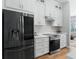 Modern kitchen with stainless steel appliances and white shaker cabinets at 7675 W Highway 326, Ocala, FL 34482