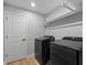 Laundry room with washer, dryer, and overhead shelving at 7675 W Highway 326, Ocala, FL 34482