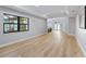 Open living room with hardwood floors and view to kitchen at 7675 W Highway 326, Ocala, FL 34482