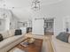 Bright living room features a vaulted ceiling, light hardwood floors, and a barn door leading to an office at 7675 W Highway 326, Ocala, FL 34482