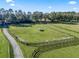 Large grassy paddock with a black rail fence and a shelter at 7675 W Highway 326, Ocala, FL 34482