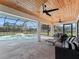 Relaxing screened-in pool area with patio furniture and wooden ceiling at 7675 W Highway 326, Ocala, FL 34482