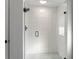 Walk-in shower with glass enclosure and white tile surround at 7675 W Highway 326, Ocala, FL 34482