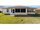 Backyard view showing a large screened-in patio and expansive lawn at 8086 Sw 81St Loop, Ocala, FL 34476
