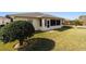 Spacious backyard with grassy area and screened patio, perfect for outdoor enjoyment at 8086 Sw 81St Loop, Ocala, FL 34476