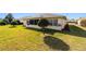 Home boasts a large backyard with lush grass and mature landscaping at 8086 Sw 81St Loop, Ocala, FL 34476