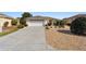 Front view of house with driveway and landscaping at 8086 Sw 81St Loop, Ocala, FL 34476